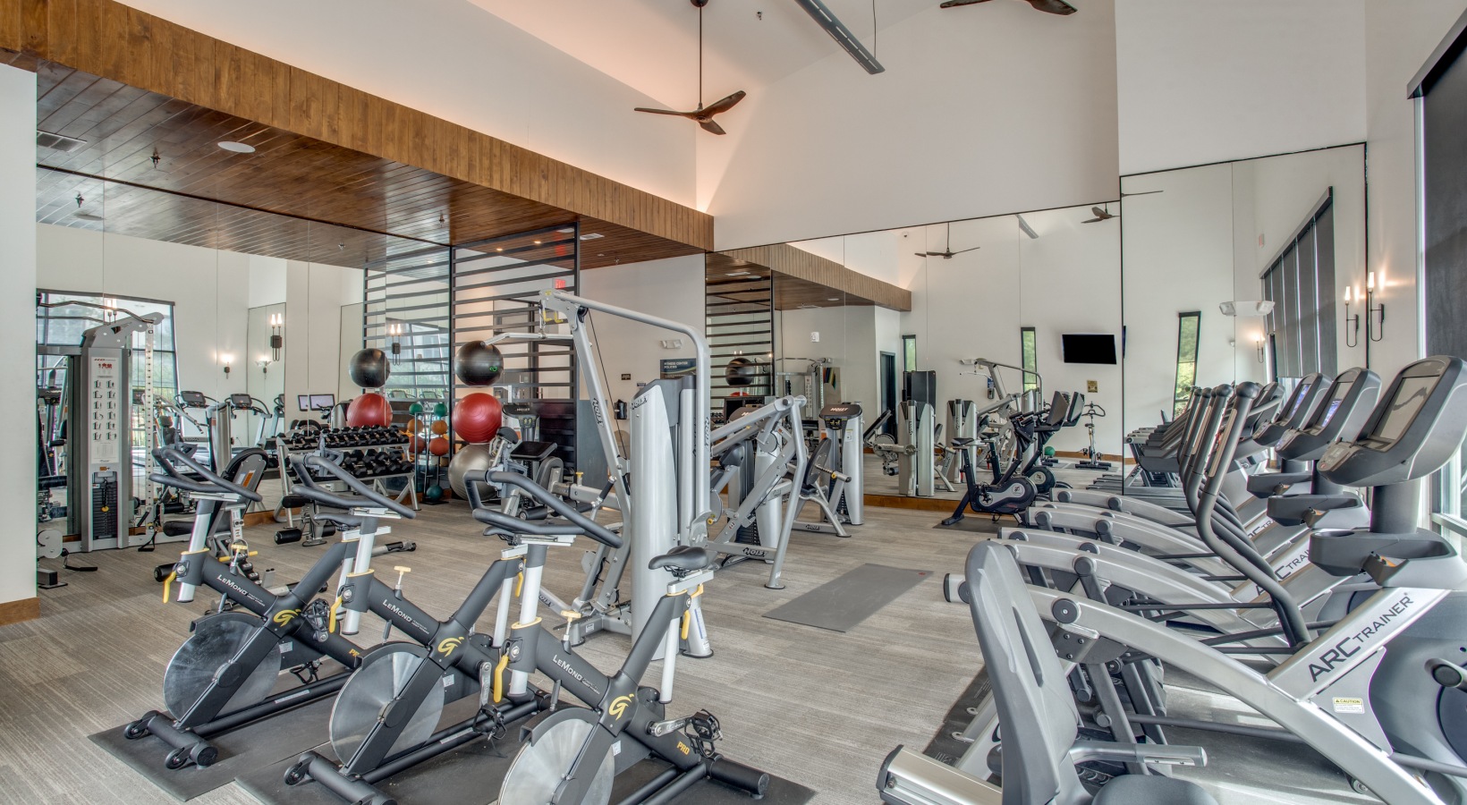 a gym with many exercise machines and mirrors at The Twin Creeks Crossing