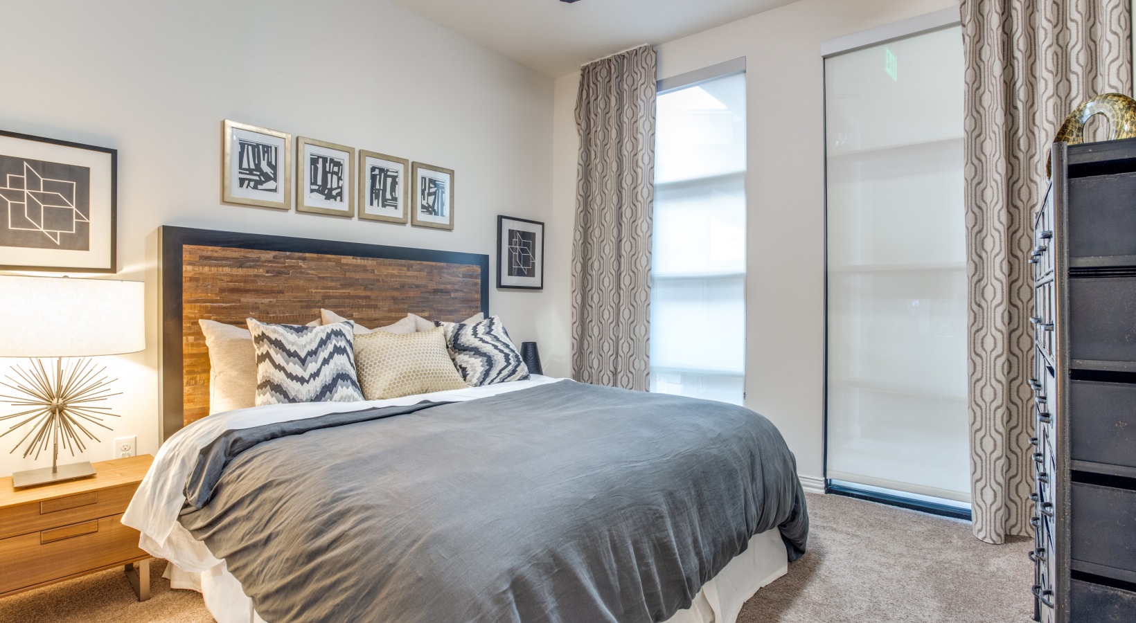 a bedroom with a large bed and a nightstand at The Twin Creeks Crossing