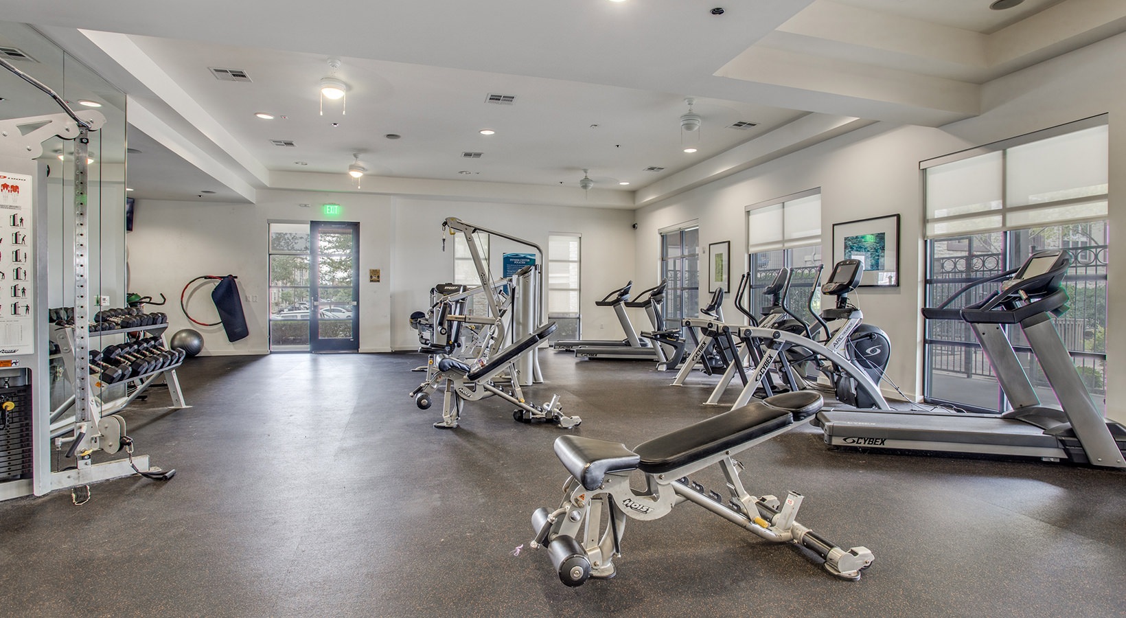 a gym room with exercise equipment and mirrors at The Twin Creeks Crossing