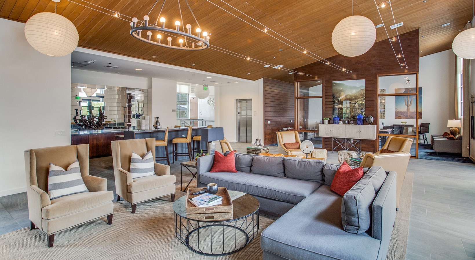 the living room has a large ceiling fan and a large table at The Twin Creeks Crossing