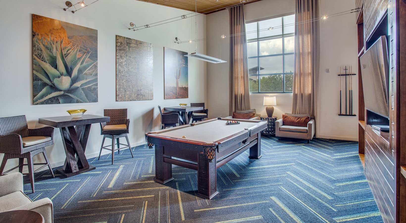 a pool table in a living room with blue walls at The Twin Creeks Crossing